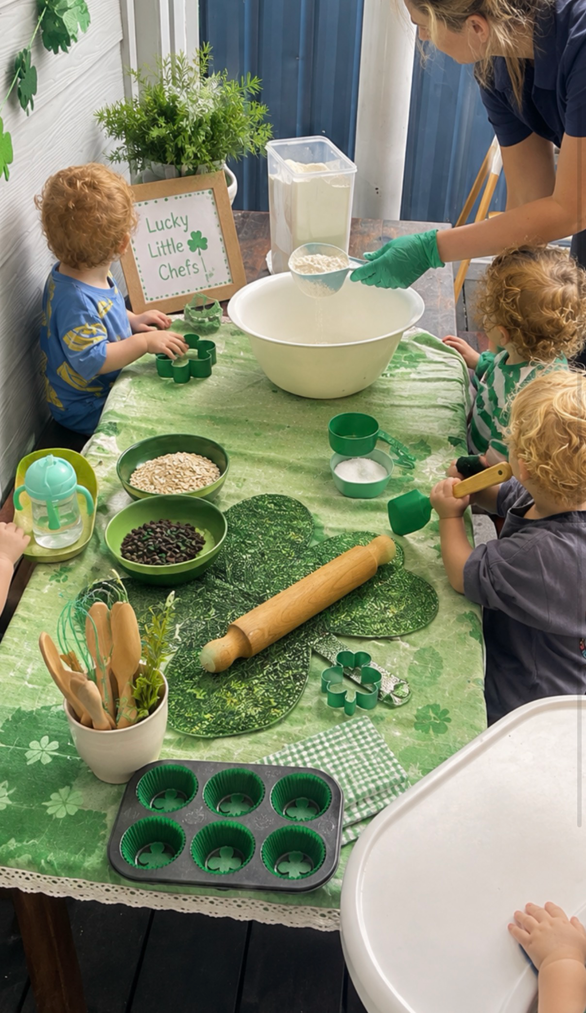Children measuring ingredients during a St Patrick's Day cooking experience